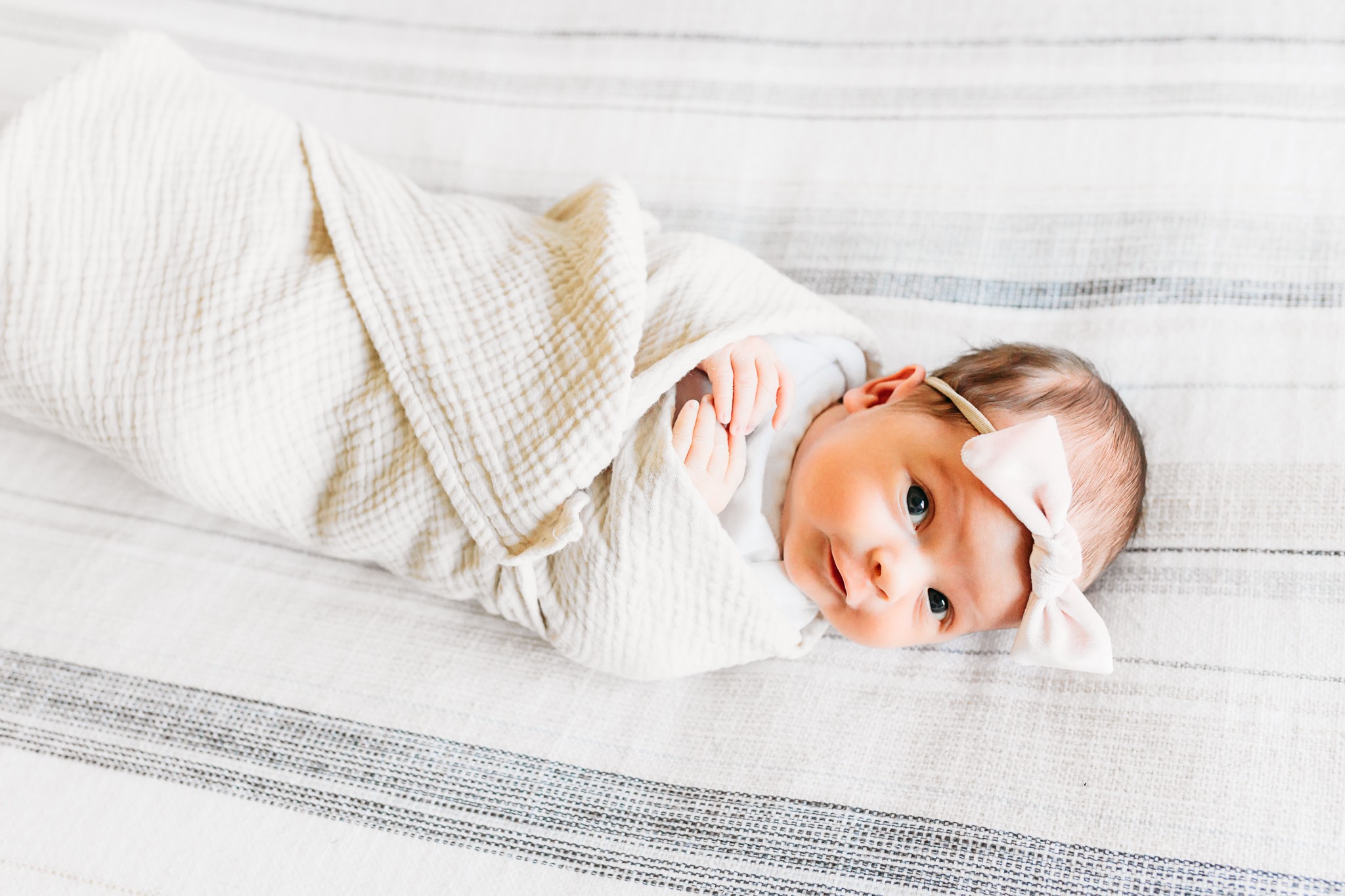 little one looks up during newborn session.