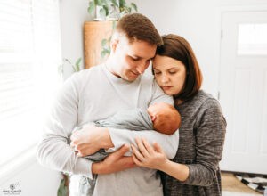 Parents hold new baby.