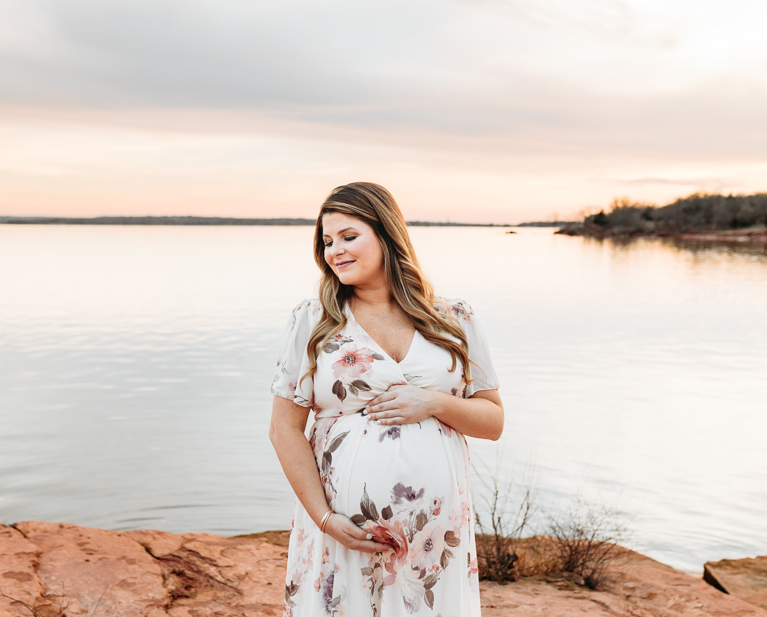 An expecting mom during maternity session at Lake Arcadia.
