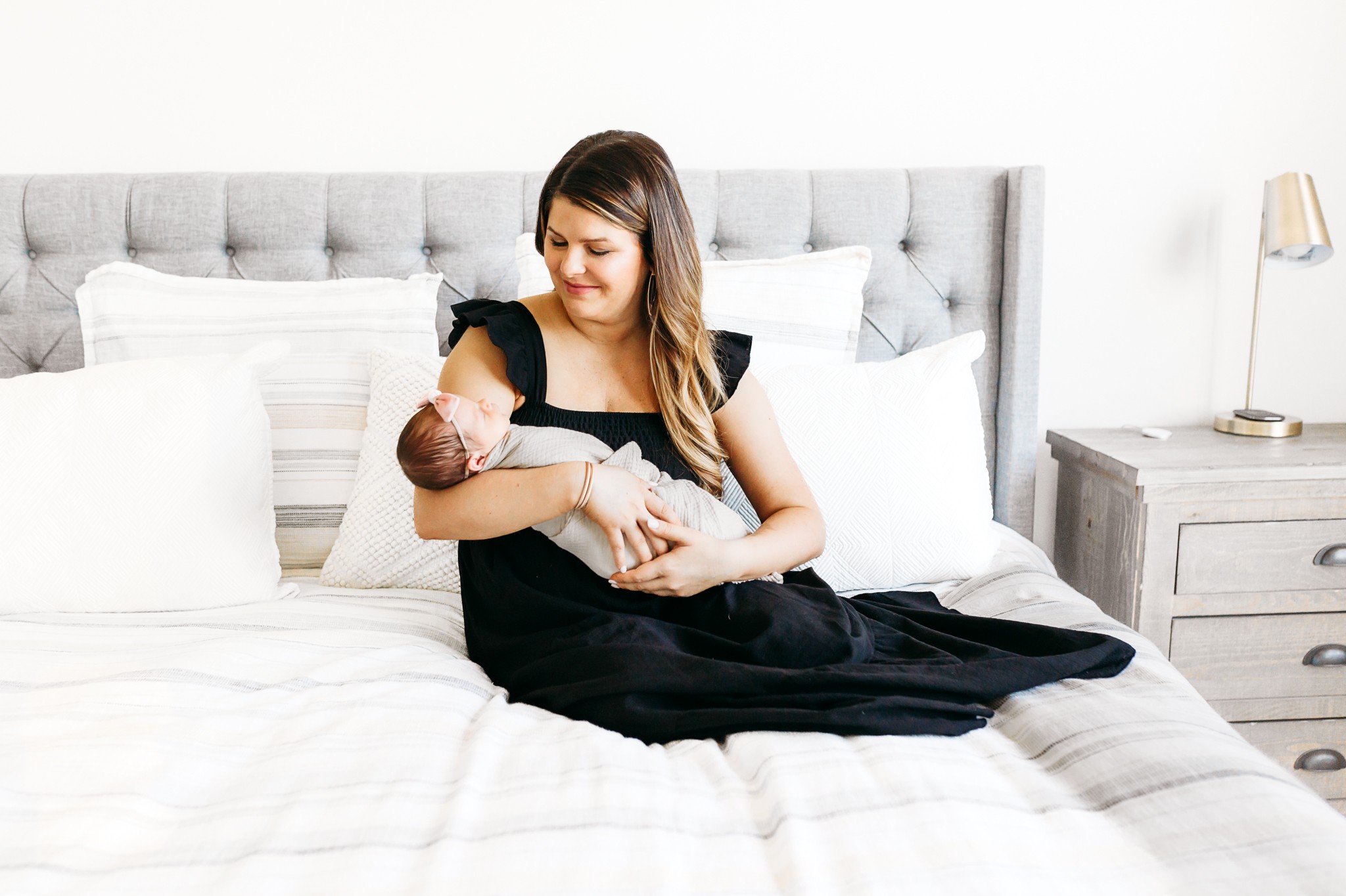 Mom snuggles baby during newborn session.
