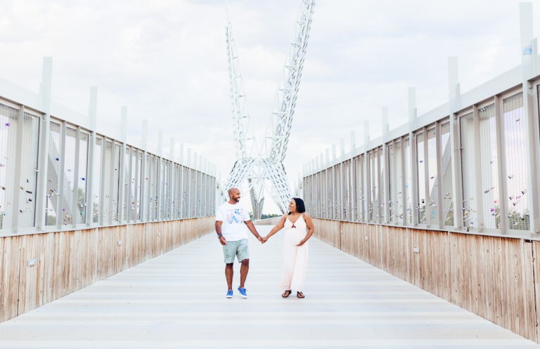 A couple poses on the Skydance Bridge in OKC during maternity session.
