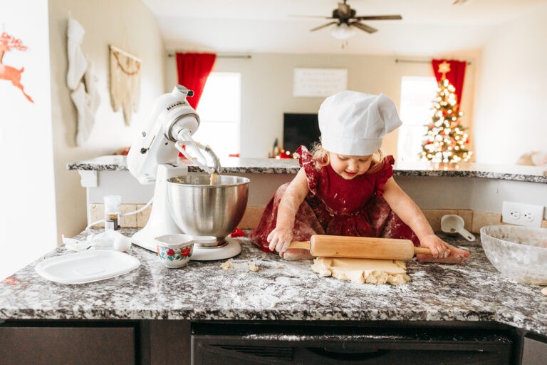 Little girl in red dress making cookies in OKC at home photo session.