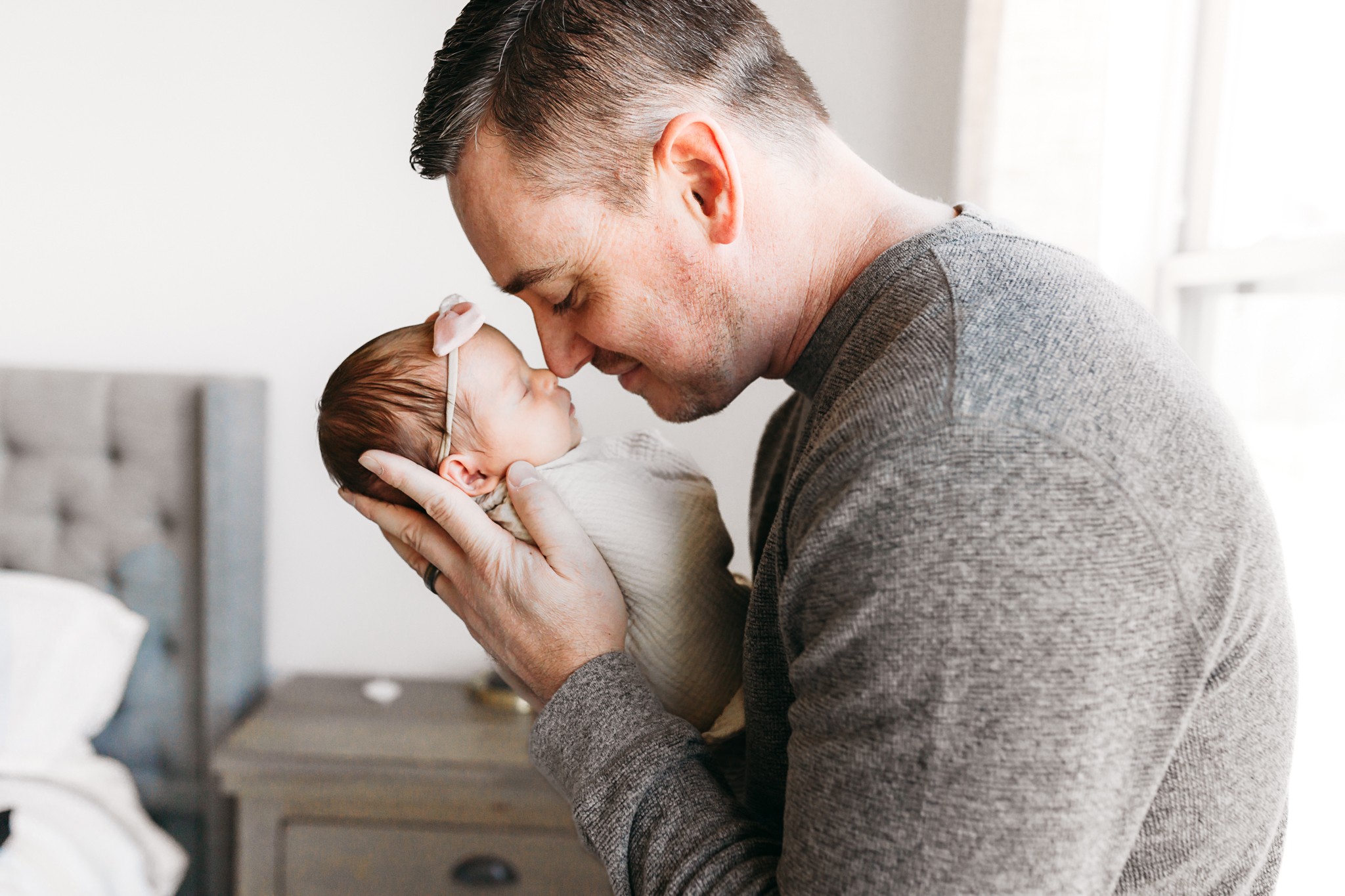 Dad holds new baby during OKC newborn photo session.